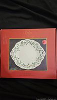 Box front showing Lenox Holiday pierced dessert server plate design with holly leaves and red berries wreath.