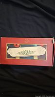 Photo showing boxed Lenox Tidbit Tray with red box and tray image on front, highlighting product and condition.