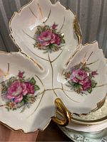 Front view of vintage associated china tri-section dish with pink floral design and gold trim