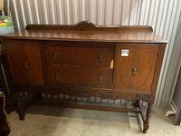 Full front view of vintage wooden buffet showing drawers, doors, legs and overall design.