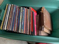 Large bin holding over 75 albums and 78 RPM records in various sleeves and binders, showing variety and quantity of collection.
