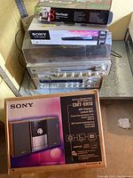 Full view of the entire stacked lot showing the turntable, receiver, and three unopened boxed items.