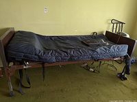 Full view of hospital bed with air mattress overlay and Salute DX controller mounted on side