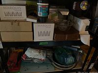 Photo showing Marquis by Waterford boxed glass sets, glass salad bowl, travel mug, and other kitchenware items on shelf