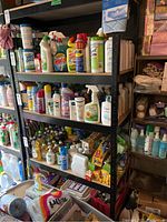 Full view of metal shelf loaded with assorted cleaning and personal care products.