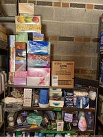 Photo showing stacked boxes of assorted facial tissues in various designs and brands including Kleenex.