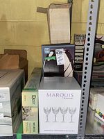 Boxed set of Waterford Marquis Markham all purpose wine/goblets, set of 4, in white box with purple text.