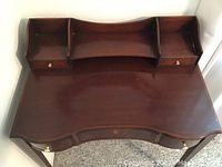Top view of mahogany dressing table showing serpentine front and three back railing compartments