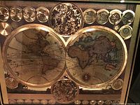 Close view of large double hemisphere nautical world map with decorative circular insets and maritime compass rose.