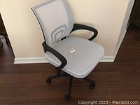 Side front view of white mesh desk chair with black armrests and wheeled base