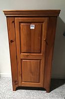 Front view of the pine pie safe showing its paneled door and natural wood finish.