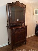 Full view of two-piece oak step-back cabinet in room