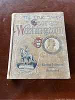 Front cover of the book showing title, author, and engraved images related to George Washington.