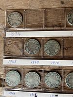 Coins arranged in clear holders with visible years from 1874 through 1914.