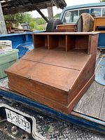 Front view of antique pine slant top desk showing solid pine construction and slant top with lock.