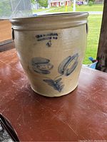 Front view of crock showing maker’s mark and blue floral decoration