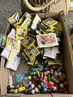 Large box filled with numerous unopened Weirdos collector card packs and Mighty Beanz collectible toys.