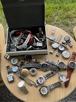 Overhead view of all timepieces laid out beside open box