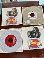 Photo showing Beatles Forever 45 RPM vinyl records (two copies) and Supertramp 45 single in paper sleeve