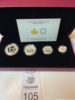 Set of four fractional silver coins featuring the maple leaf, displayed in presentation box with certificate card.