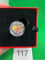 Photo of the 2019 Celebration of Love silver coin with colorful roses, capsule inside red velvet-lined box.
