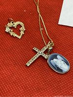 Chain and pendants arranged on red background