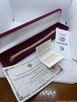 Gold color bracelet with double-row simulated diamonds in original Camrose & Kross box with certificate and MaxSold tag