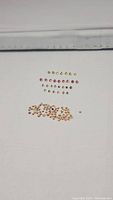 Assorted loose mixed color sapphires arranged in groups by color and size on a white background, showing clarity and cut.