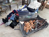 Full view of lot showing boots, dress shoes, shoe forms, assorted folded clothing and bin/bag