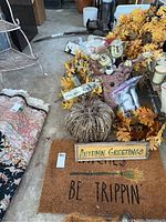 Overview of multiple fall-themed items including wreaths, scarecrows, pumpkin decor, gnome fabric doll, and doormat