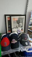Framed 1945 and 1949 LIFE magazine covers, Patriots and Red Sox caps including championship caps