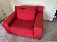 Front view of red oversized club chair with two back cushions and wide armrests