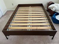 Top view of the Ikea twin bed frame showing wood finish, horizontal wooden slats, and metal frame support.