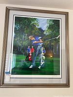 Full view of the professionally framed print showing golfer Chi Chi Rodrigues in mid-swing with caddies and forest background.