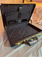 Opened briefcase showing interior organization with multiple compartments and dunhill logo fabric lining