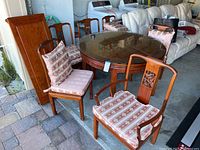 Full set overview showing round table with glass top, chairs and cushions
