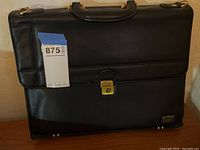 Full view of the black leather briefcase showing overall condition and size.