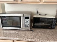 Both appliances on countertop showing microwave on left and toaster oven on right