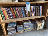 Two shelves filled with a variety of Chinese DVDs and Video CDs with colorful covers and spines