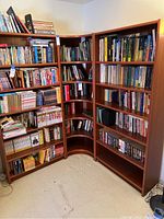 Shows all three pieces assembled in a corner with books displayed. Highlights overall condition and size.