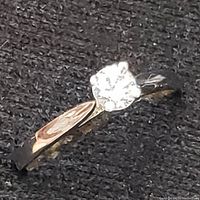 Front angle view of ring showing diamond and band curvature.