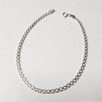 Silver 9-inch anklet laid out flat showing chain and clasp