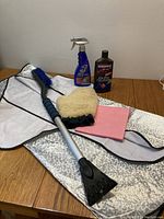 Photo showing all items in the lot together: windshield protector, snow brush with scraper, lambswool mitt, car wax bottle, and Wax-As-U-Dry spray wax.