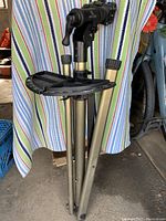 Bike Hand bicycle repair stand folded, showing tripod legs and clamp adjustment knobs