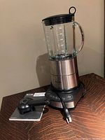 Breville blender assembled with manual and blade removal tool placed in front