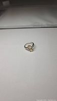 Natural golden citrine 925 silver ring with two oval faceted stones on silver band viewed from an angle.