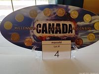 Full oval display with 12 Canadian Millennium 2000 quarters, labeled 'CANADA Millennium 2000 Millénaire'