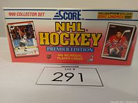 Front view of the factory sealed 1990 SCORE NHL Hockey Premier Edition box. Shows 445 bilingual player cards and includes five exclusive Eric Lindros cards. Images of Wayne Gretzky and Eric Lindros on box front.