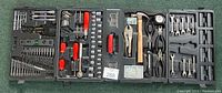 Top-down view of the opened case showing the full assortment of tools including wrenches, pliers, hammer, sockets, and screwdriver heads.