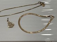 Overview of both bracelets and ship’s wheel charm laid flat
